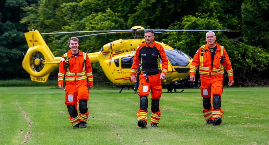 Crew walking away from helicopter on grass