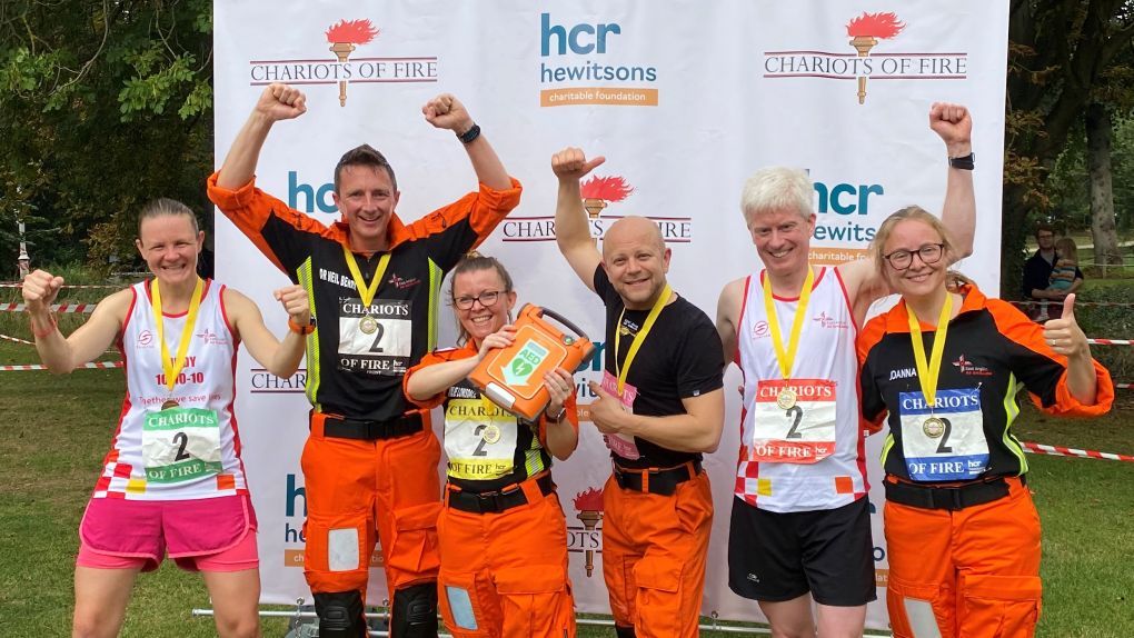 EAAA Chariots of Fire team celebrating at the finish with a defibrillator