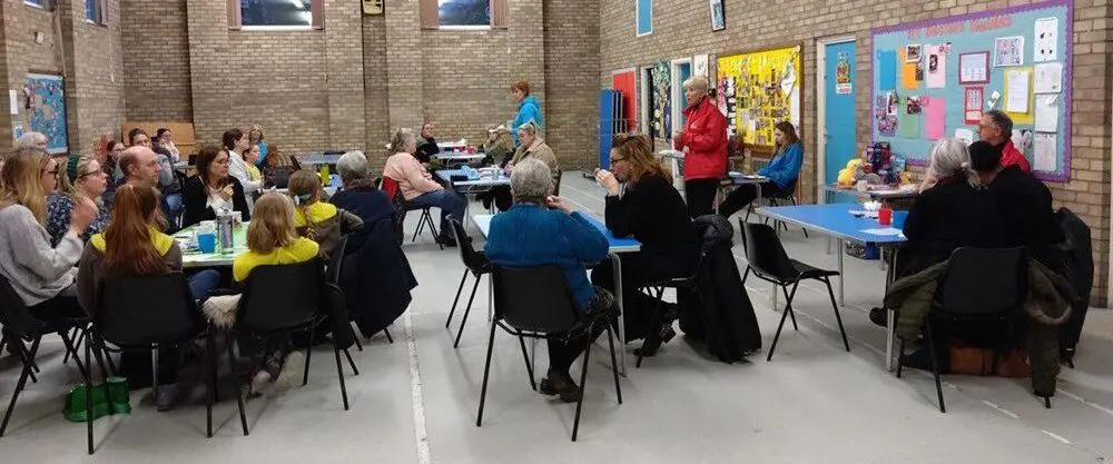 EAAA volunteer presenting to a room full of people sitting down