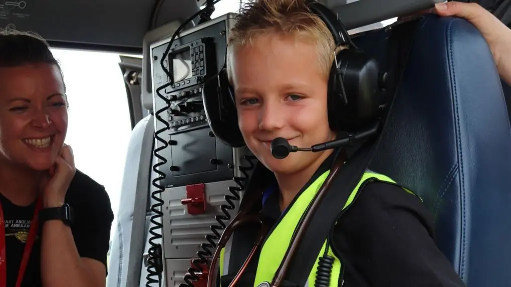 Jack Jinkerson sitting in the EAAA helicopter wearing earphones and microphone.