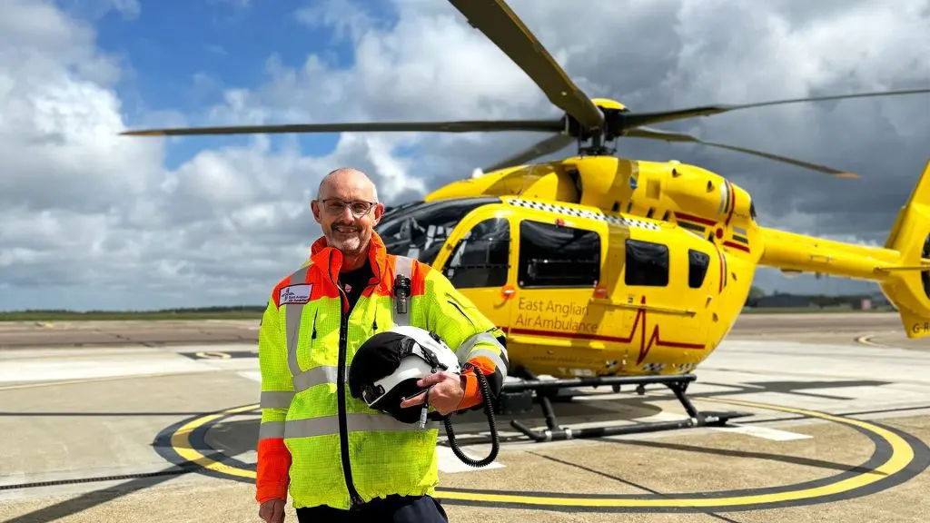 Pilot Steve Norris stood in front of EAAA helicopter