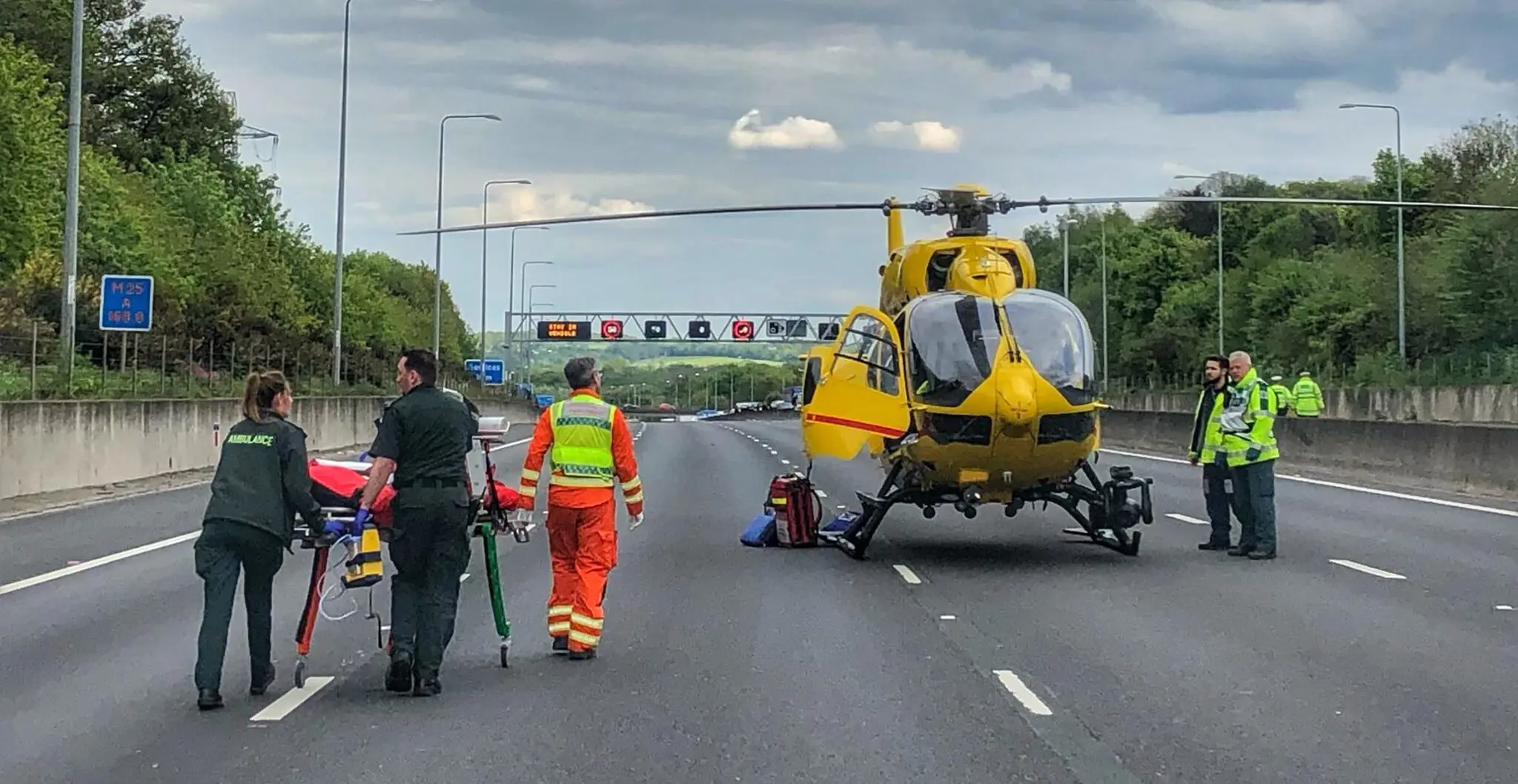 Helicopter landing on motorway with crew
