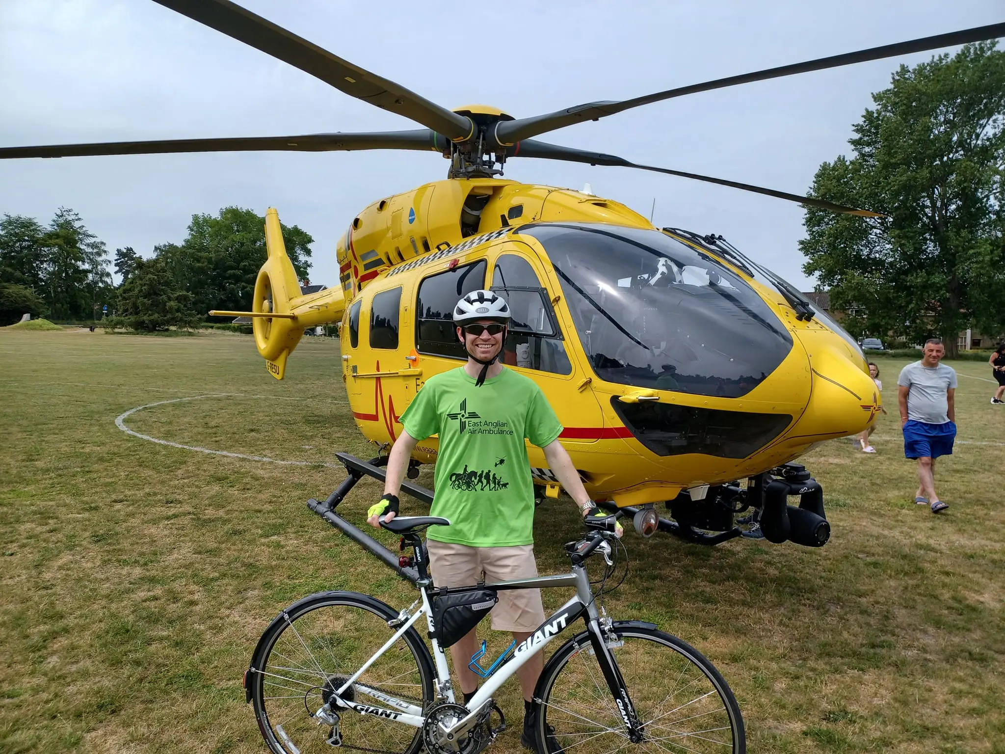 TWR Cyclist in front of helicopter