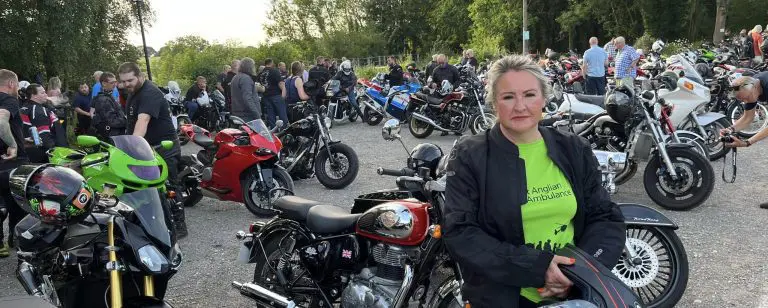 TWR Motorcyclist standing in front motorbikes