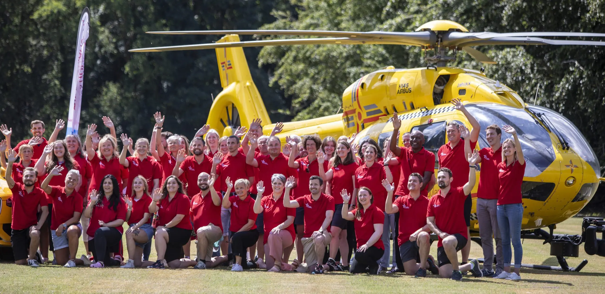 EAAA staff waving infront of helicopter