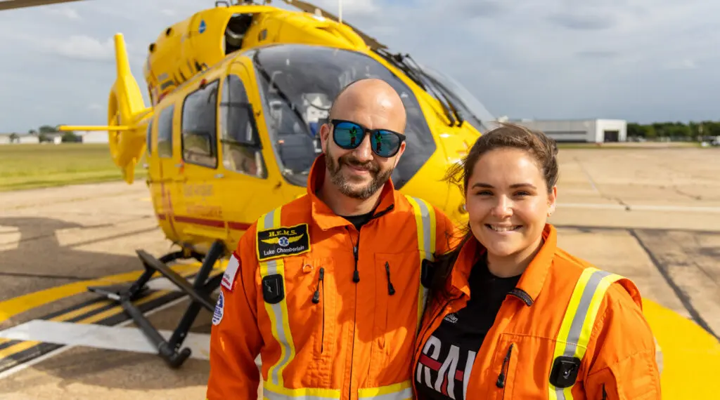 Critical Care Paramedics Luke and Page infront of helicopter