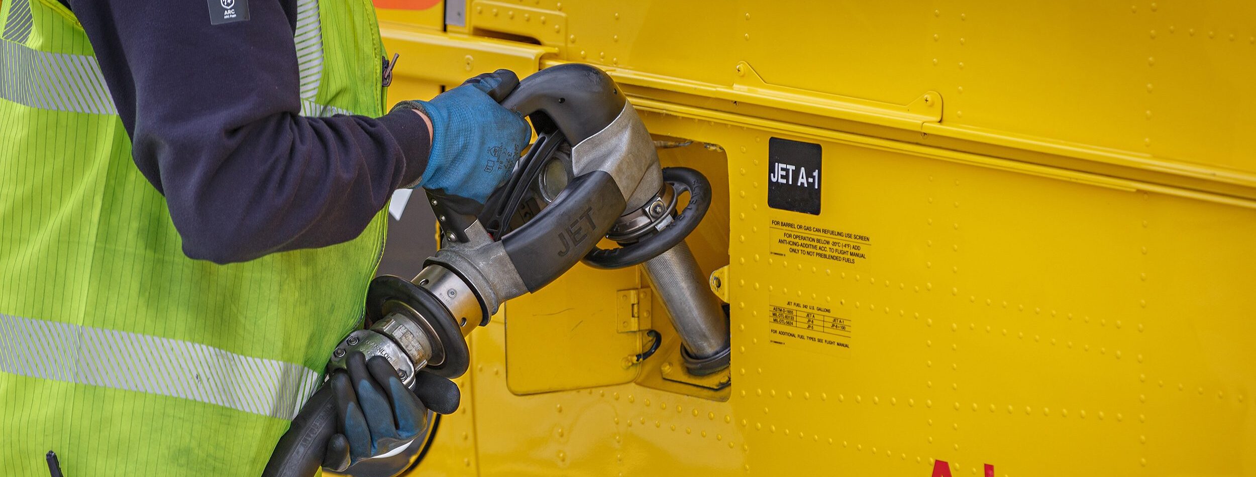 Yellow helicopter being refuelled at Norwich Airport