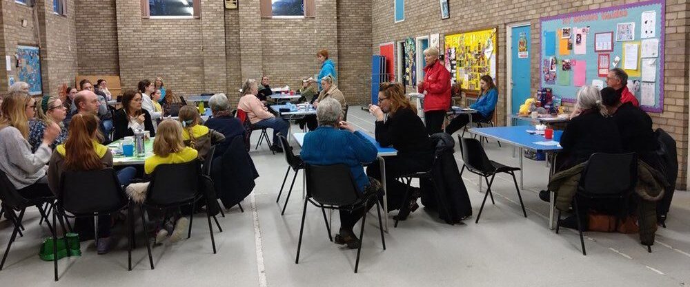 EAAA volunteer presenting to a room full of people sitting down