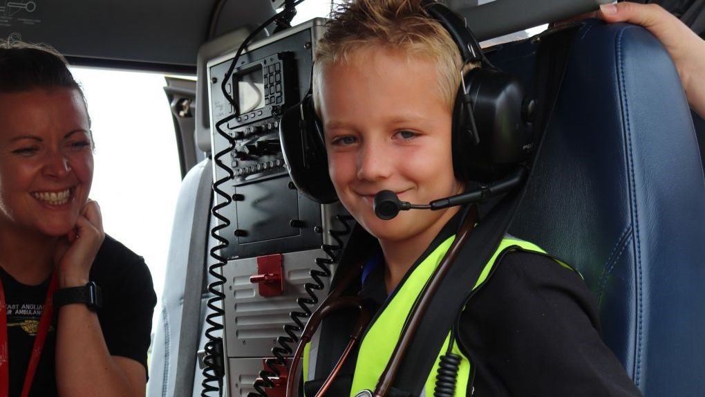 Jack Jinkerson sitting in the EAAA helicopter wearing earphones and microphone.
