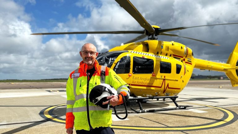 Pilot Steve Norris stood in front of EAAA helicopter