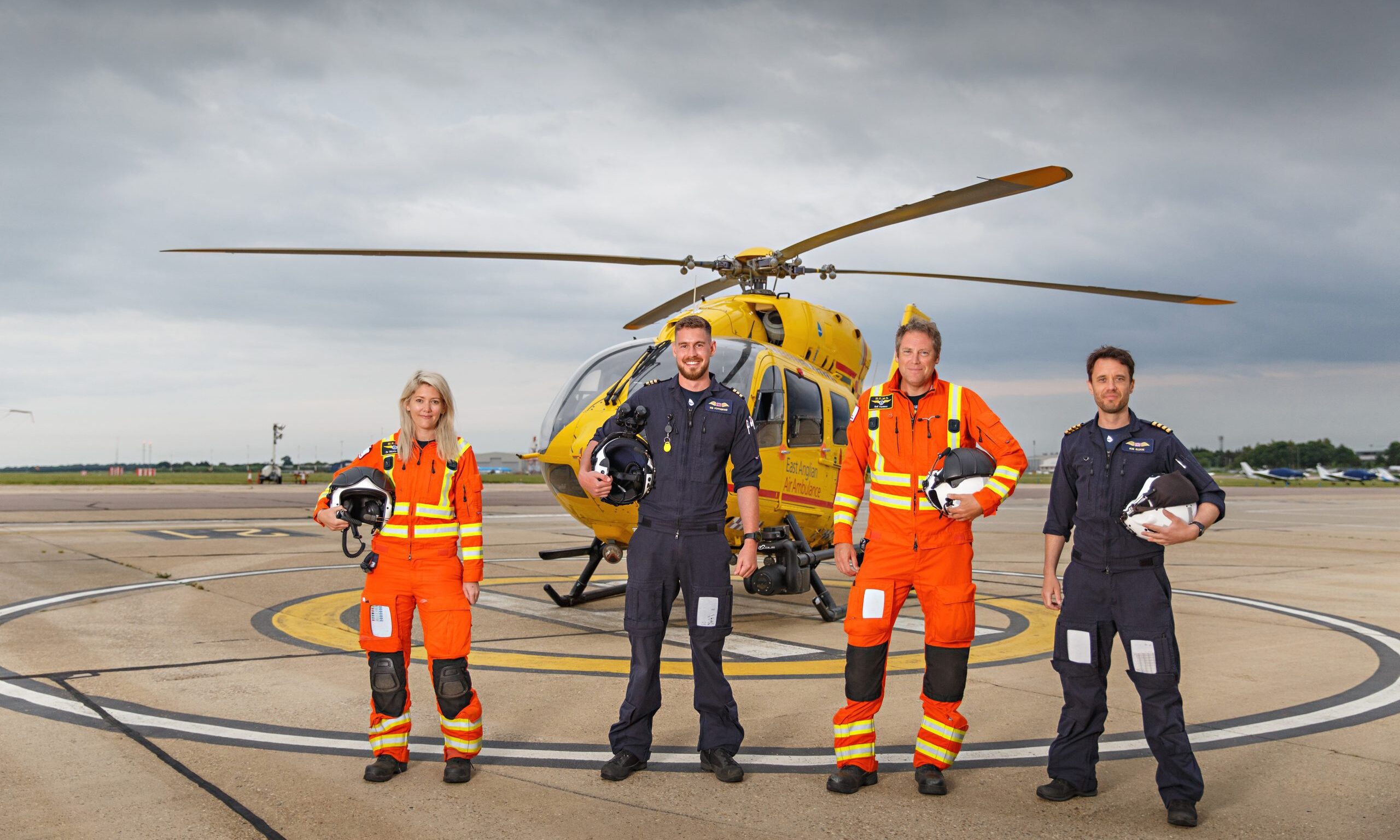 Crew standing in front of Helicopter