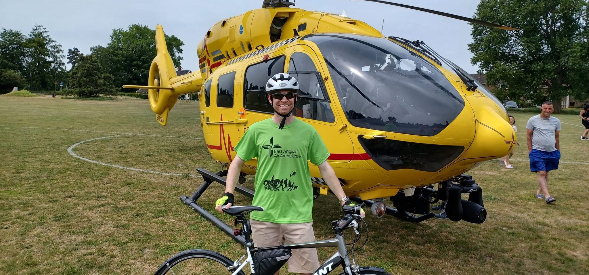 TWR Cyclist in front of helicopter