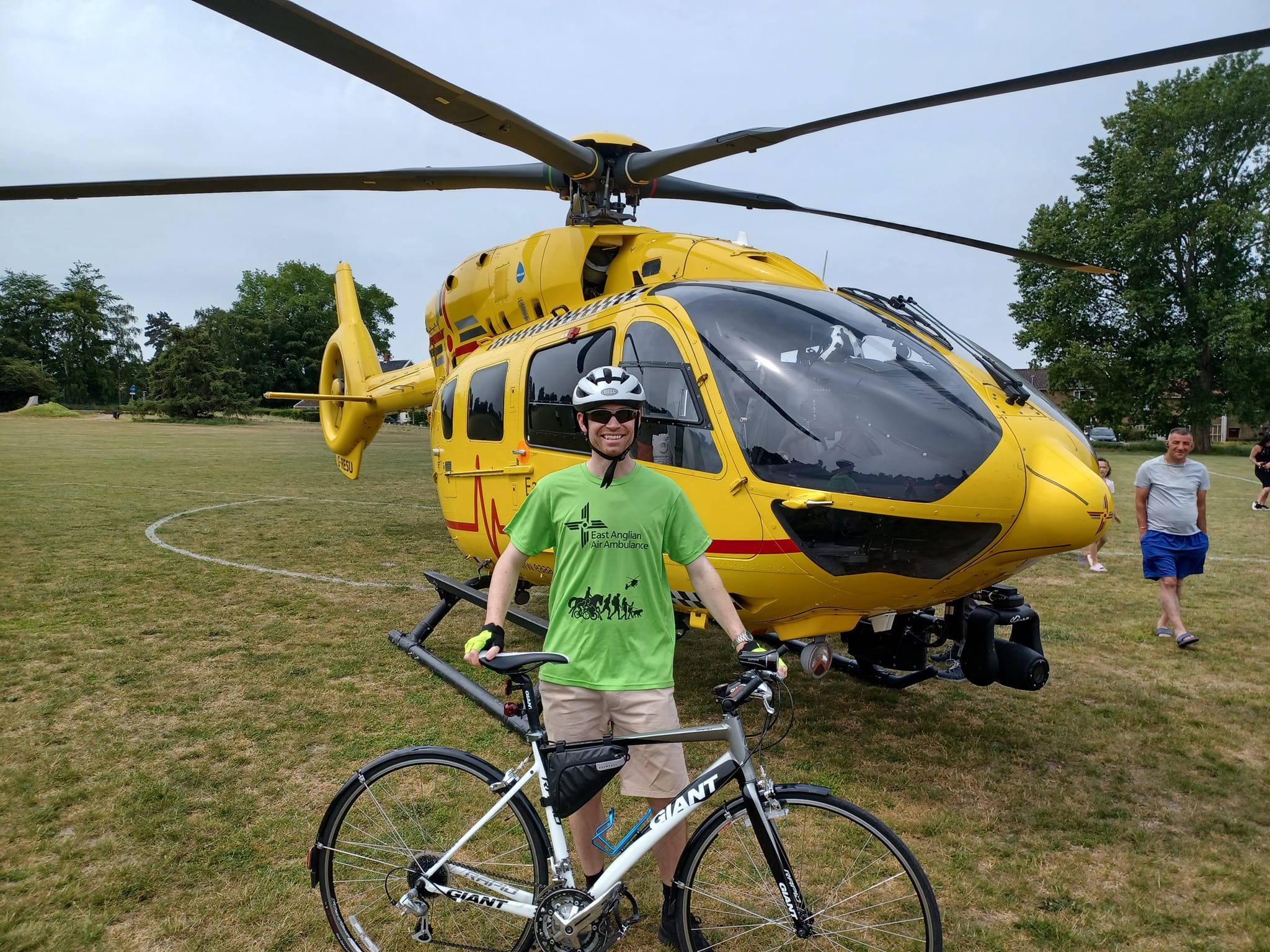 TWR Cyclist in front of helicopter