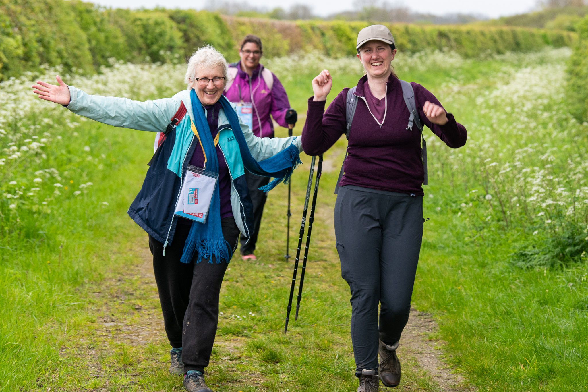 Two women with open arms walking Trek 24 Bedfordshire