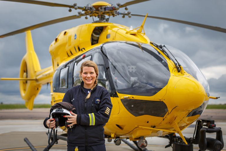 Captain Henrietta standing in front of helicopter