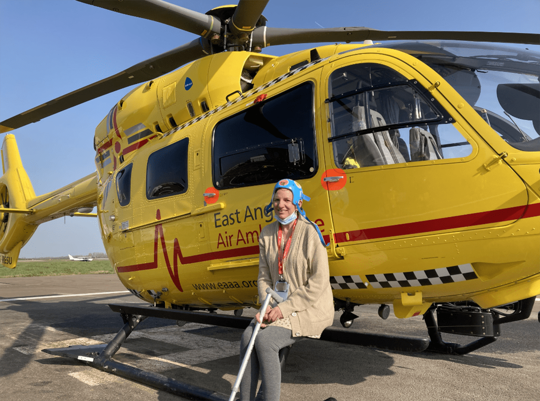 Cathryn in front of helicopter