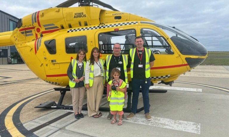 Roger at family in front of helicopter