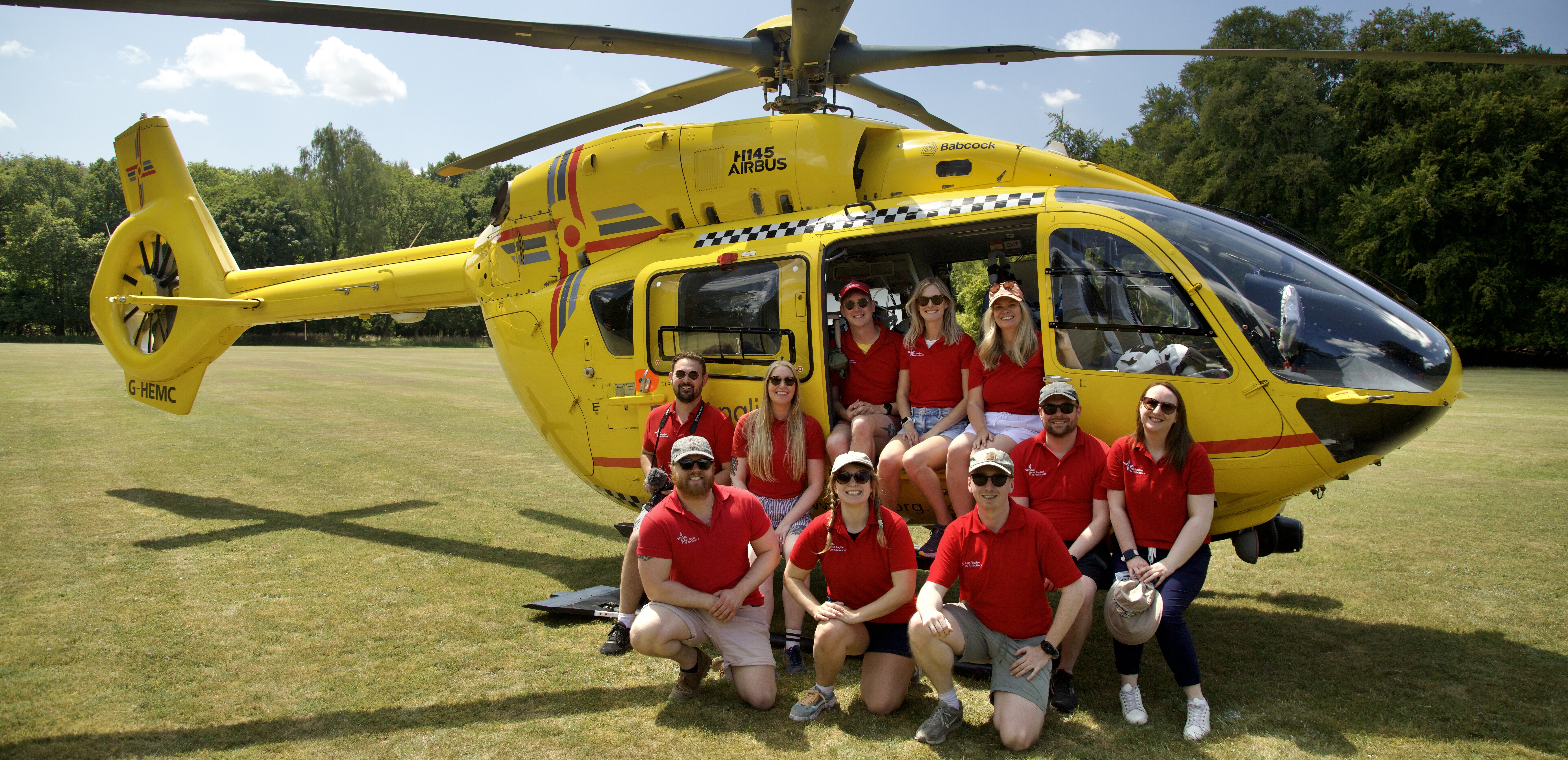 EAAA Marcomms team infront of heli