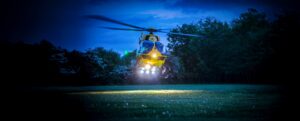 EAAA Heli with landing lights on in field